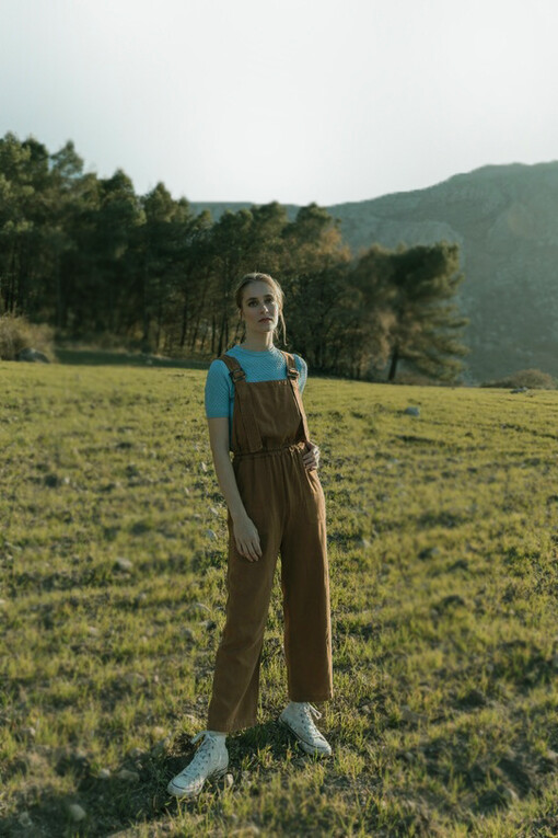 Immersed in nature, a woman explores self-discovery and emotional layers, fostering inner growth and personal transformation on her healing journey