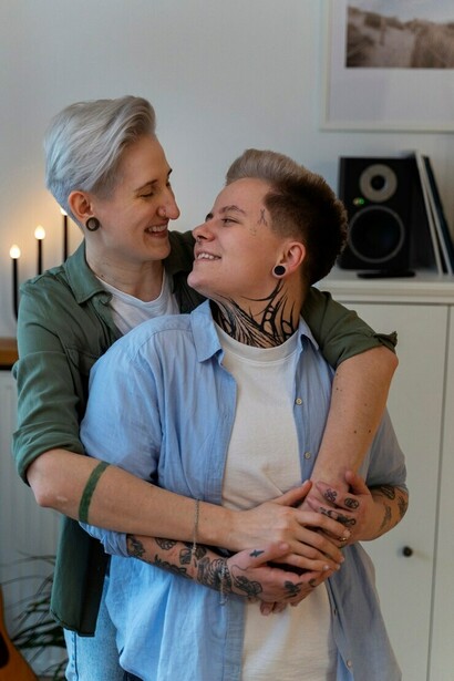 A loving LGBTQ+ couple enjoying each other's company at home, showcasing the intimacy and trust that define their romantic relationship
