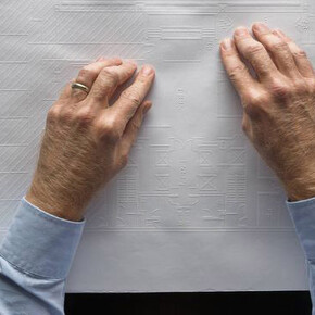 Chris Downey reading a braille and printed architectural plan, Don Fogg, 2017. © Don Fogg