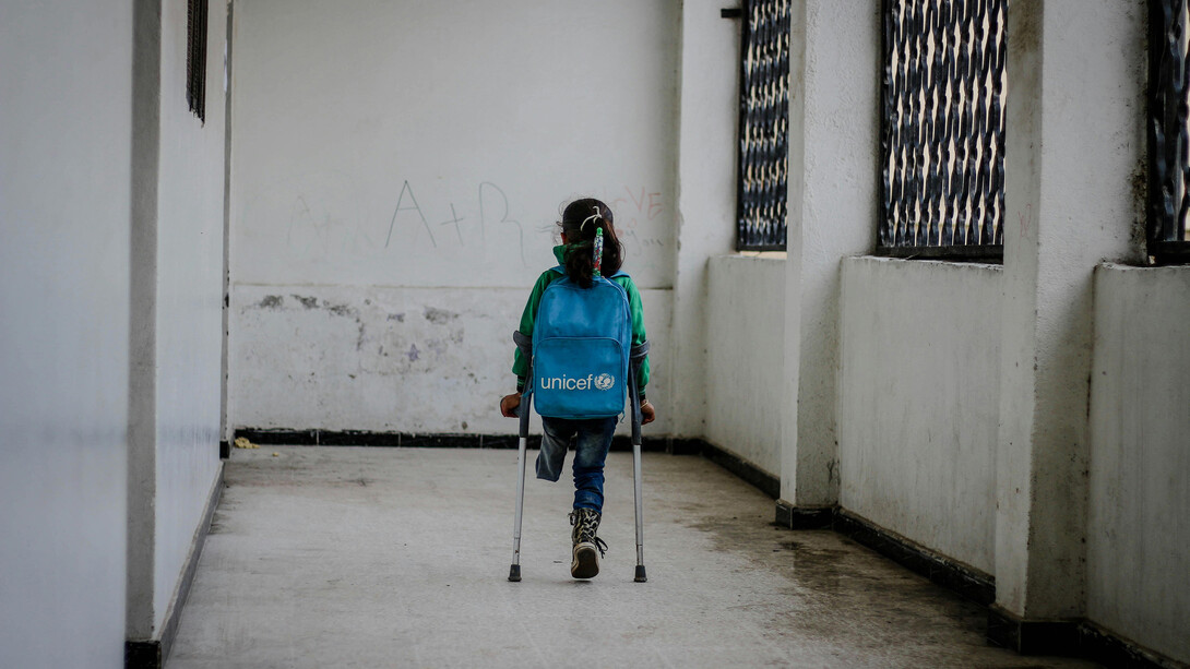 A young girl, who lost her leg in the war, walking to school in Idlib, Syria, highlighting the resilience of children in conflict zones