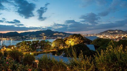 The evening lights of Nagasaki seen from Glover Garden cascading across the hillsides, reflecting the city's warm and enduring spirit 
