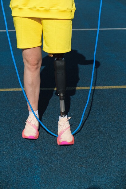 A person wearing yellow with a skipping rope 