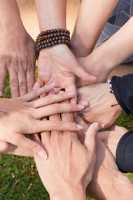 Hands gently resting on lush green grass