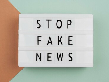A bold lightbox message saying “Stop fake news,” reflecting public concern over misinformation in political narratives