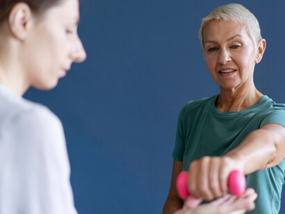 A woman lifting pink dumbbells, strengthening  arms with repetitive workouts