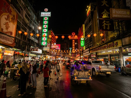 People walking along a street in Bangkok at night, Bangkok, Thailand
