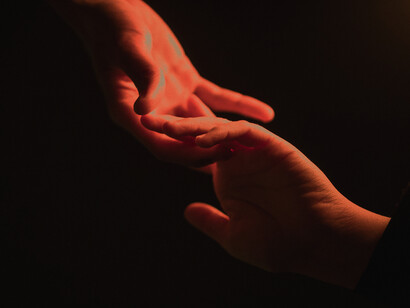 Two hands showing a farewell touch