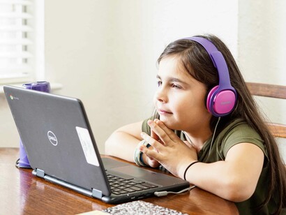A young and eager student trying to remain enthusiastic in front of her laptop in the new normal