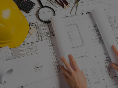 Skilled architect expertly opening blueprint, showcasing precision and expertise in architectural design