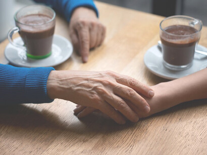 Hands clasped in support, reflecting generosity, reciprocity, and the meaningful exchange of kindness through giving and receiving