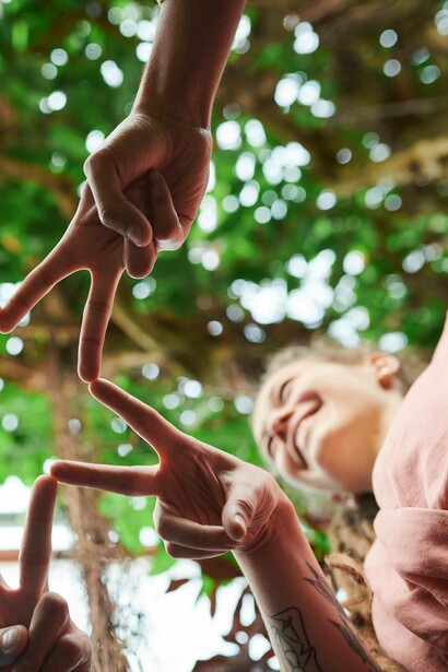 Team members smile as they join fingers
