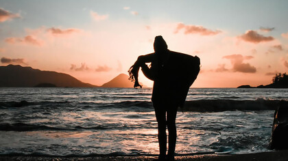 Silhouette of woman standing on the seashore