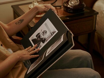 A young woman looking at a photo album
