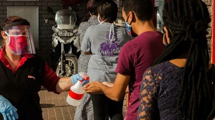 South Africans lining up waiting to be cleared of Covid-19 as they attempt to enter the governmental building