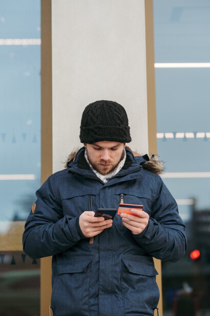 A man inputting his bank details into his phone 