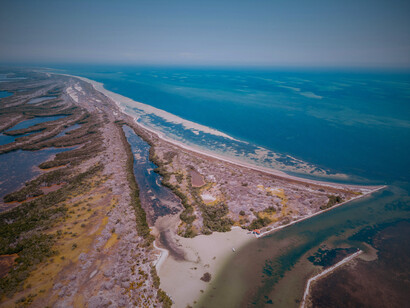 An aerial glimpse of the Yucatán Peninsula—a stage where history, ecology, and introspection converge for those who look beyond the chaise lounge