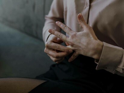 Removing the wedding ring symbolizes the end of a marriage