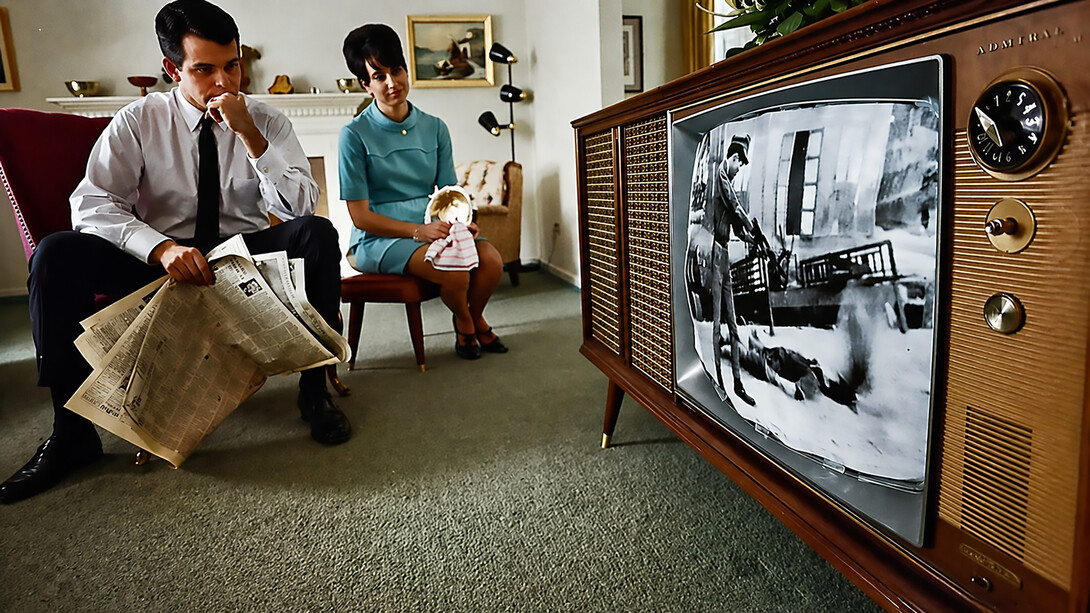 A family watches televised war coverage on the evening new