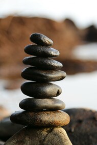 Pile of rocks next to a lake 