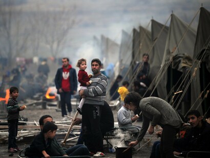 Migrants and refugees in a camp