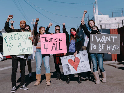 Protesters gather, unified in their outrage, questioning the logic behind widespread societal trends and the herd mentality that drives them