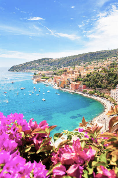 The scenic beauty of Villefranche-sur-Mer, nestled in the Provence-Alpes-Côte d'Azur region along the enchanting French Riviera, France, with its picturesque shoreline adorned with boats