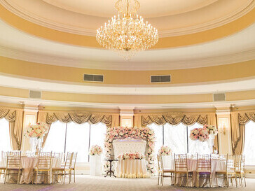 A stunning wedding venue, tastefully decorated with lush flower bouquets