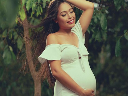 Pregnant woman holds her belly