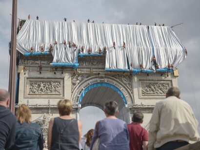 Fabric panels are being unfurled in front of the outer walls of the Arc de Triomphe —1, Photo: Benjamin Loyseau © 2021 Christo and Jeanne-Claude Foundation