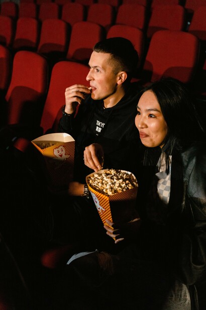 A couple enjoys popcorn at the cinema