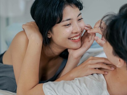 A couple smiling and being playfully intimate in their relationship
