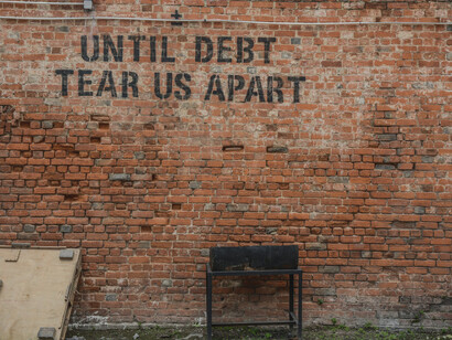 Writing on a wall condemning the ruthless cycle of debt