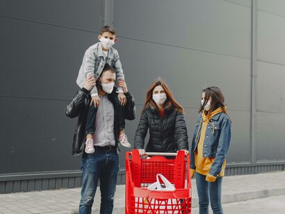 A family still insists on having their children wear masks even on supermarket outings