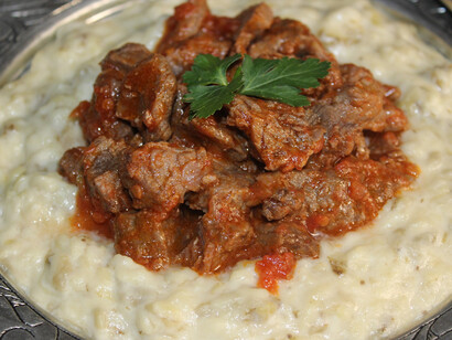 Resting upon a classic serving plate, a tantalizing Hünkar Beğendi dish beckons with its irresistible allure
