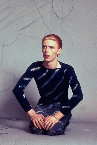 David seated drawing circles on the background paper and then the Kabbalah Tree of Life diagram on the floor. Los Angeles, 1974