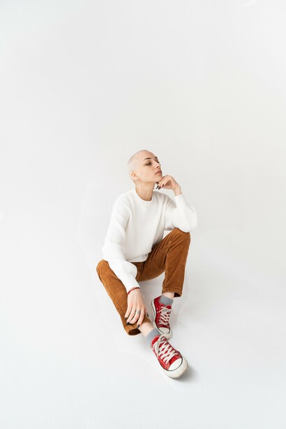 A person sat alone in a white room
