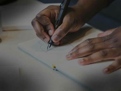 An Intern drawing on his notebook
