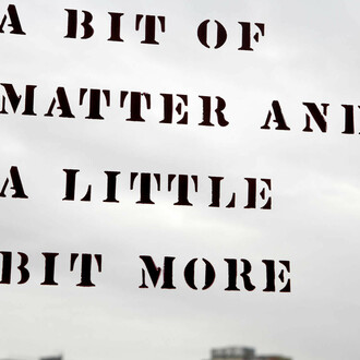 Lawrence Weiner: A bit of matter and a little bit more
Originally part of the exhibition Rooms in 1976, Lawrence Weiner wrote the title phrase on the inside of the front entrance as well as on the outside of the back door of MoMA PS1. The original doors, made of wood and metal, were removed during the renovation in 1997. After the renovation was completed, the artist was invited back to recreate the piece on both sides of the glass windows of the front doors.
Lawrence Weiner. A bit of matter and a little bit more. 1976. © 2017 Lawrence Weiner. Photo: Matthew Septimus