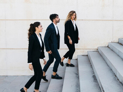 Business people climbing the corporate ladder as they walk upstairs