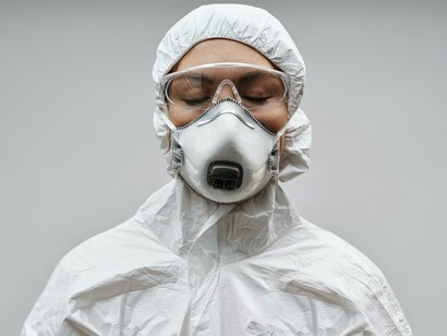 Medical professional in a white face mask, responding to COVID-19
