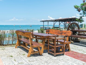 A seaside public gathering space with lighting and open visibility, symbolising principles of safe and inviting urban design