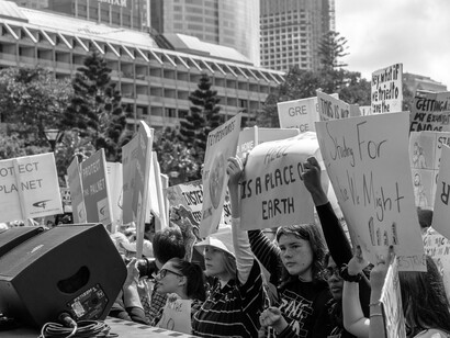 Monochrome photograph of demonstrators carrying placards during a climate change protest in Sydney, New South Wales, Australia