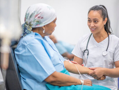 A compassionate nurse soothes a cancer patient, providing comfort and support during their treatment