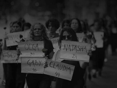 Women marching silently with names of deceased women who were victims of femicide