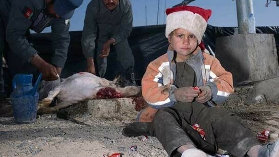 Mark Neville, Child, Jacket, Slaughtered Goat, Sweets, Painted Nails, Xmas Day, Helmand © Mark Neville