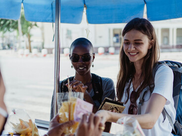 Women buying street food at a market in Asia