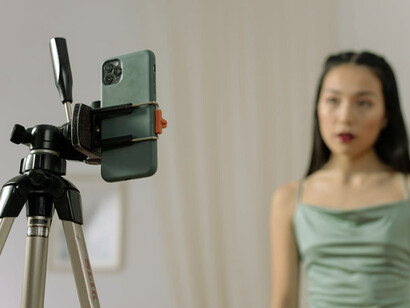 Focused on her phone, she crafts new content, drawing inspiration from recent insights on business and entrepreneurship