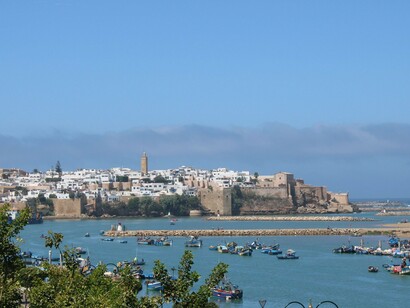 Traditional fishing boats resting offshore in Rabat, Morocco, reflecting Morocco’s coastal geography and its role in managing movement across the Mediterranean region