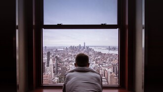 A person sat looking out of a building. Self-talk can be as varied and complex as our own personalities