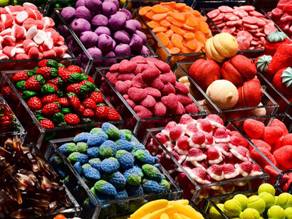 An assortment of colorful candies is arranged on display, catching the eye with their bright and playful hues